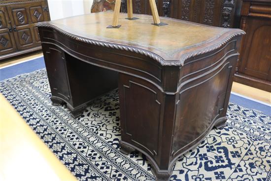 A serpentine pedestal desk, 135cm wide